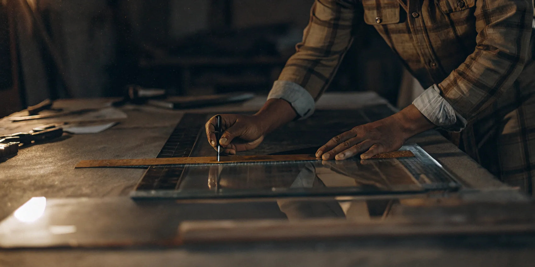 A professional cutting a custom piece of tempered glass for sale.