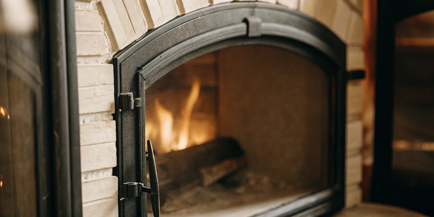 A fireplace door with a new gasket creating a tight seal as a fire burns warmly inside.