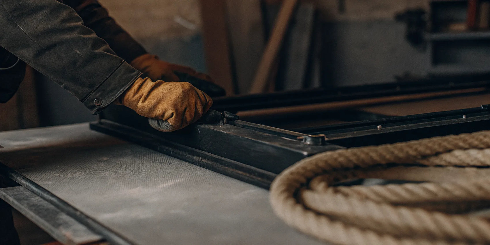 Applying cement to a new fiberglass stove gasket with a gloved hand.