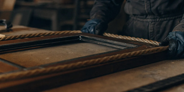 A new gasket being installed on a wood stove door for a window replacement.