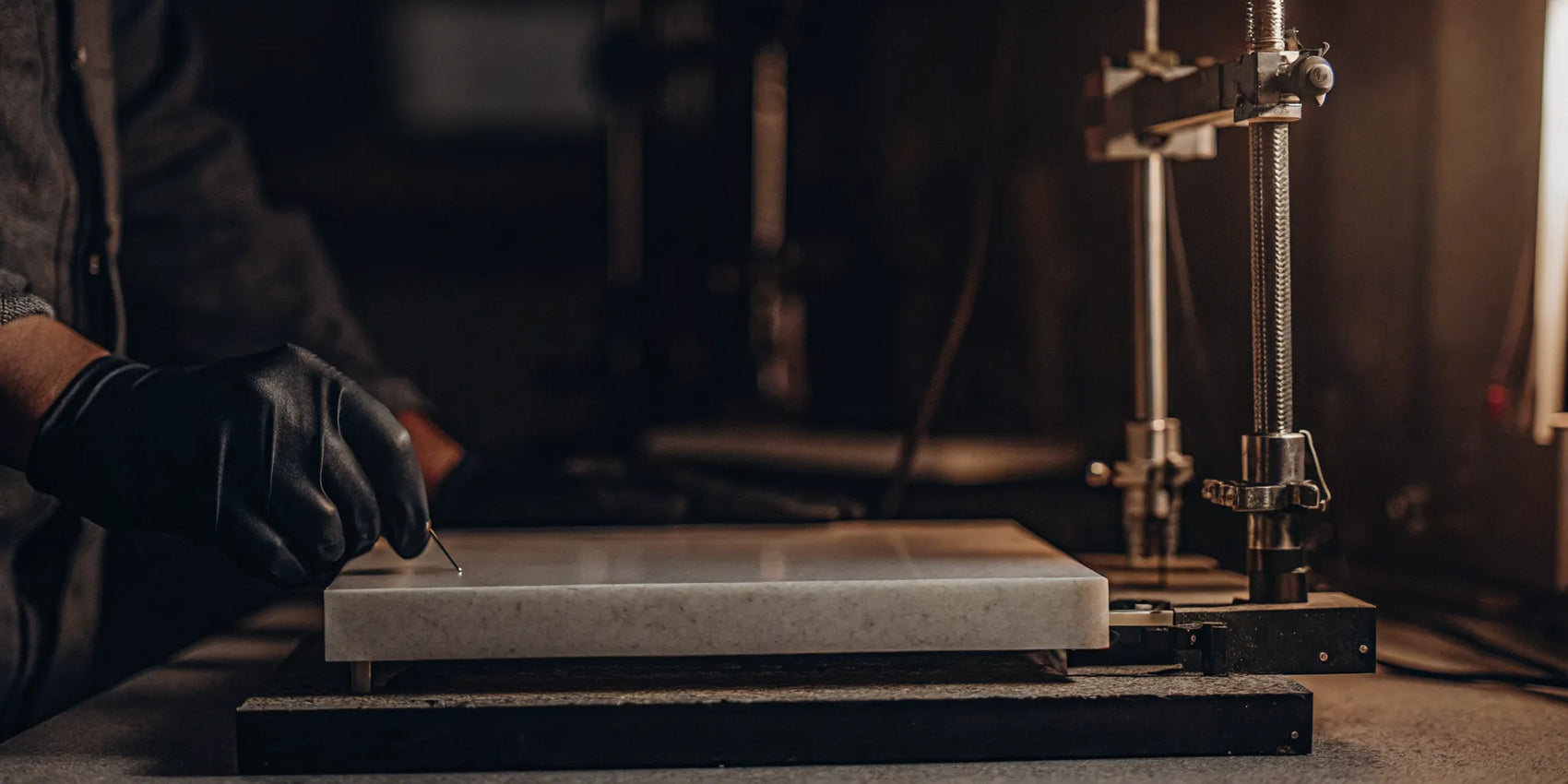 A technician tests the strength and durability of a Pyroceram 9606 glass-ceramic sample.